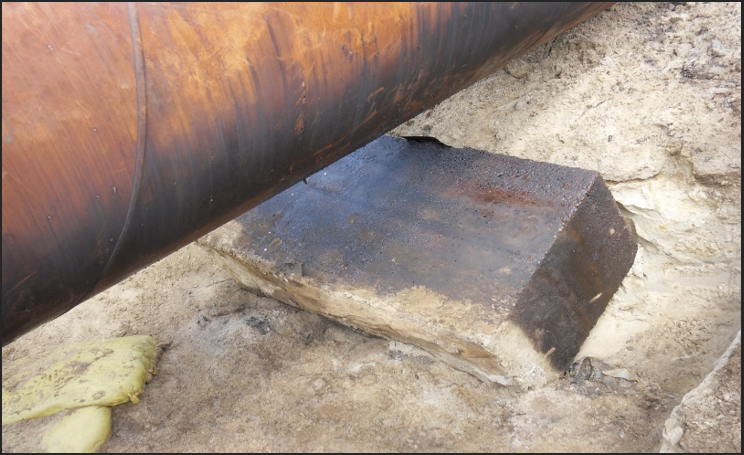 A large pipe on the ground

                                Description automatically generated