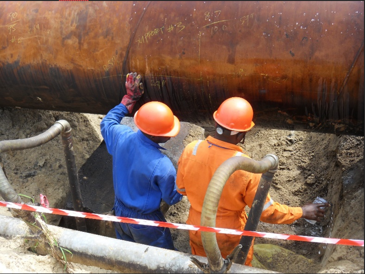 Men wearing hard hats and orange helmets
                                
                                Description automatically generated
