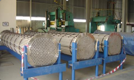 Several rolls of metal in a factory

Description automatically generated